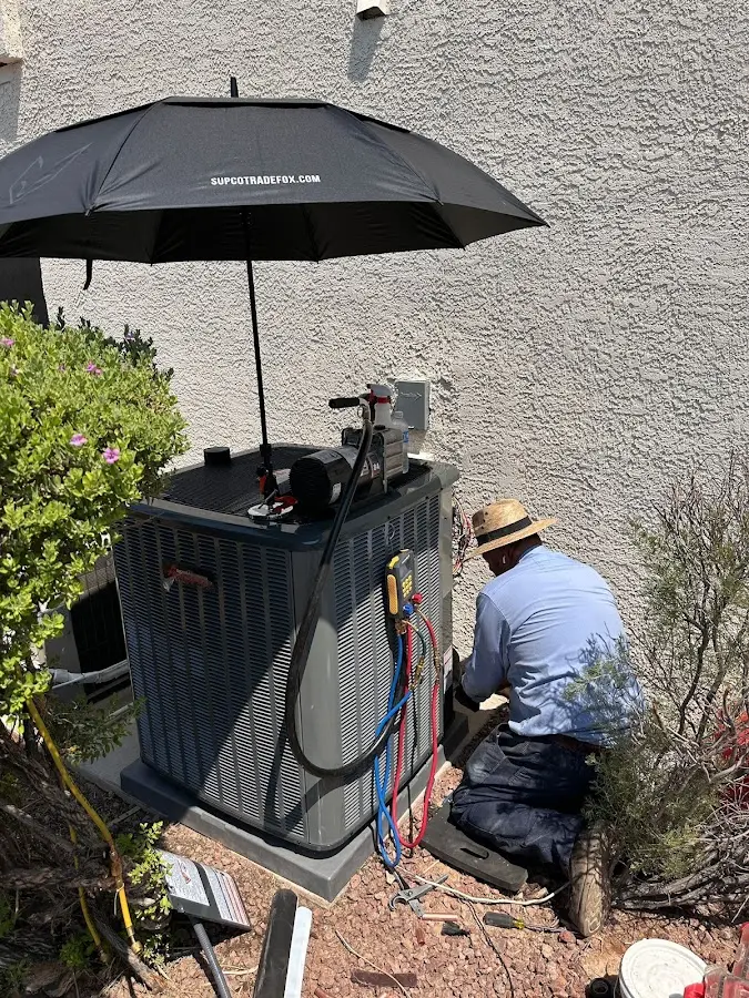 HVAC technician performing outdoor AC maintenance in Commerce City