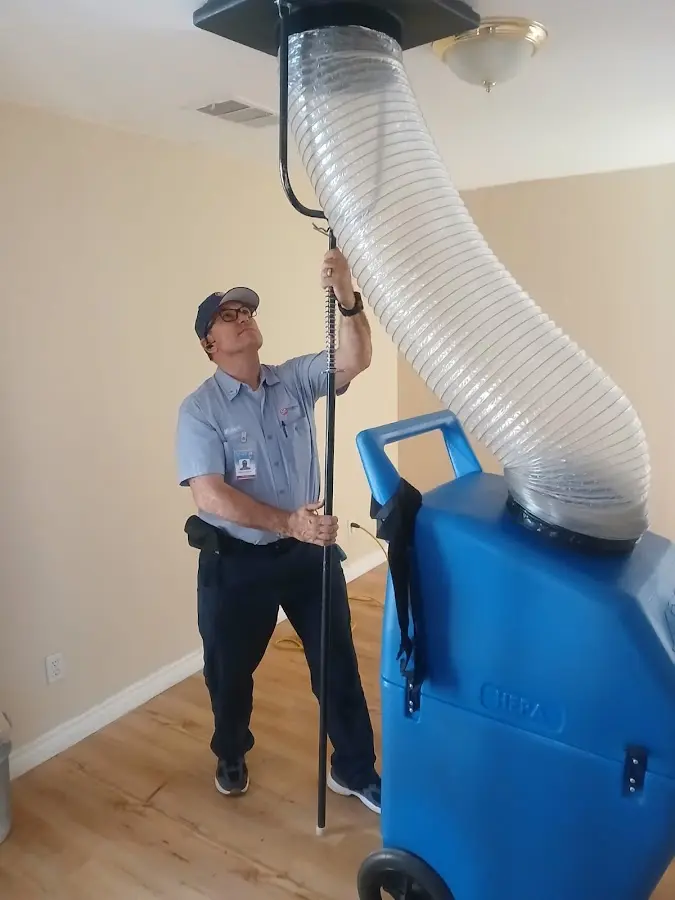 Furnace Tune-Up technician using HEPA equipment in Commerce City