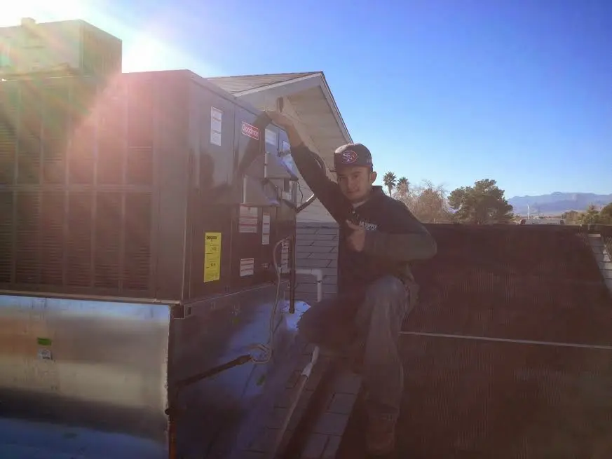 HVAC technician performing HVAC Inspection on a rooftop unit in Commerce City